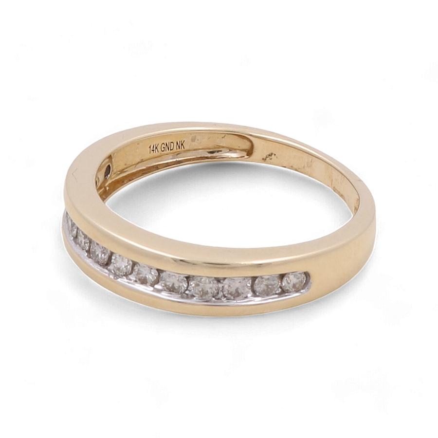 The 10K Yellow Gold Bridal Men Ring with Diamonds by Miral Jewelry features a row of small round diamonds set along the band. The inside of this exquisite ring is engraved with "14K GND NK." Combining elegance and timelessness, this ring is the perfect symbol of commitment for your special day.