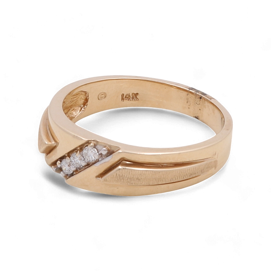 The Miral Jewelry 14K Yellow Gold Bridal Men Ring with Diamonds features a carved design and a small cluster of diamonds on one side, making it the perfect choice for a bridal men's ring.