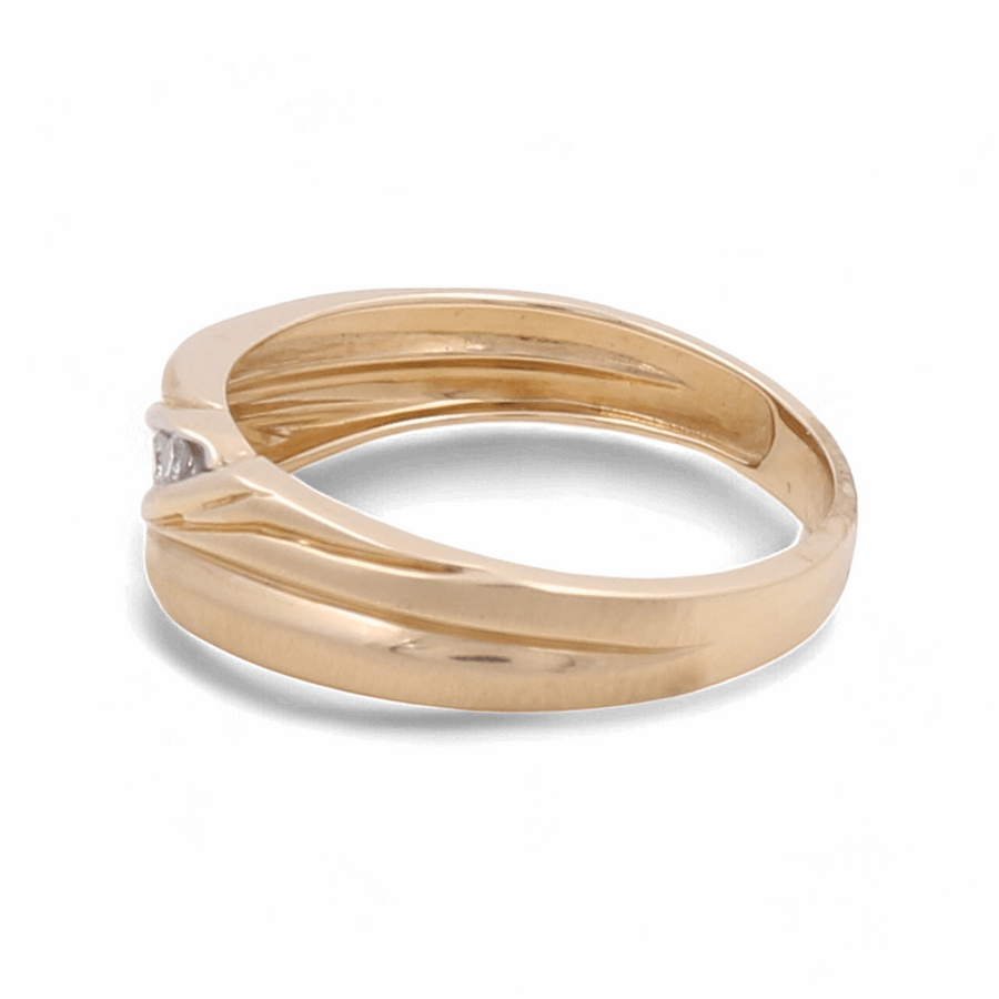 The Miral Jewelry 14K Yellow Gold Bridal Men's Ring features a simple band design with a small, central set diamond, beautifully crafted for an elegant angle view.