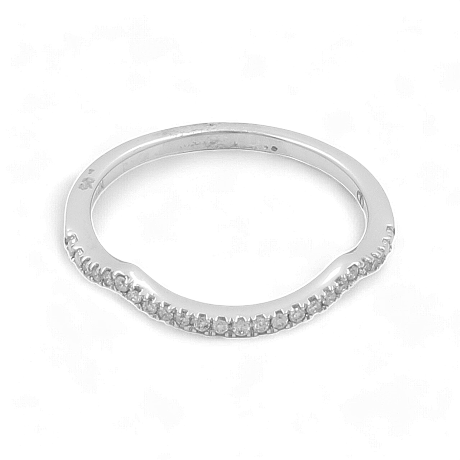 A slim 14K white gold Miral Jewelry bridal woman's ring adorned with a row of small diamonds set along one edge.