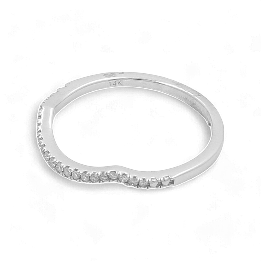 A delicate bridal ring by Miral Jewelry, crafted from 14K white gold with small diamonds adorning part of the band.