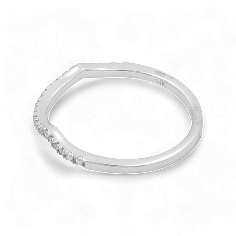 A slightly curved 14K white gold bridal ring by Miral Jewelry, featuring multiple small diamonds on the upper half. The inside of the band is marked with "14K".