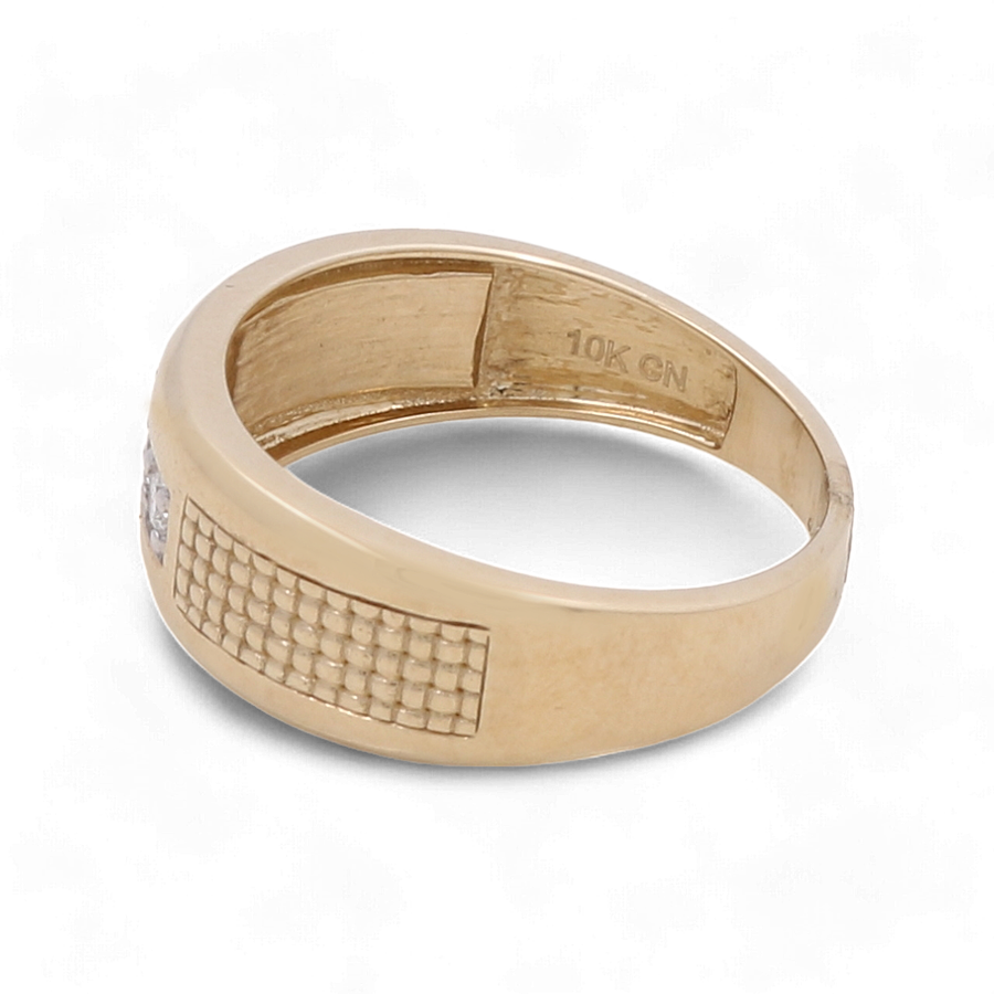 Close-up of the Miral Jewelry 10K Yellow Gold Bridal Men Ring with Diamonds featuring a woven pattern and an inscription reading "10K GM" on the inner band, perfectly complementing any 14K white gold bridal ring in your wedding ensemble.