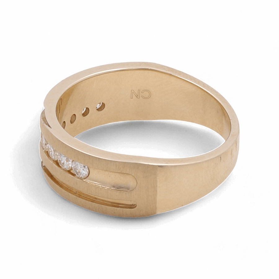 The 10K Yellow Gold Bridal Men Ring with Diamonds by Miral Jewelry is a stunning piece, featuring embedded diamonds and the initials "CN" engraved on the inner band.