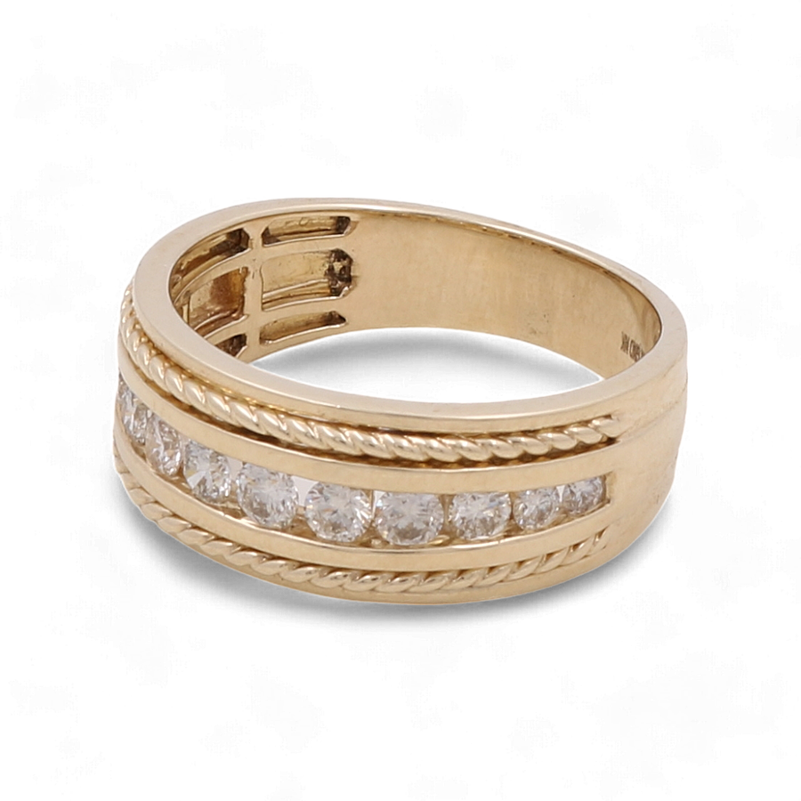 A luxurious piece from Miral Jewelry, the 10K Yellow Gold Bridal Men Ring with Diamonds showcases a lined pattern and is embedded with a row of small diamonds.