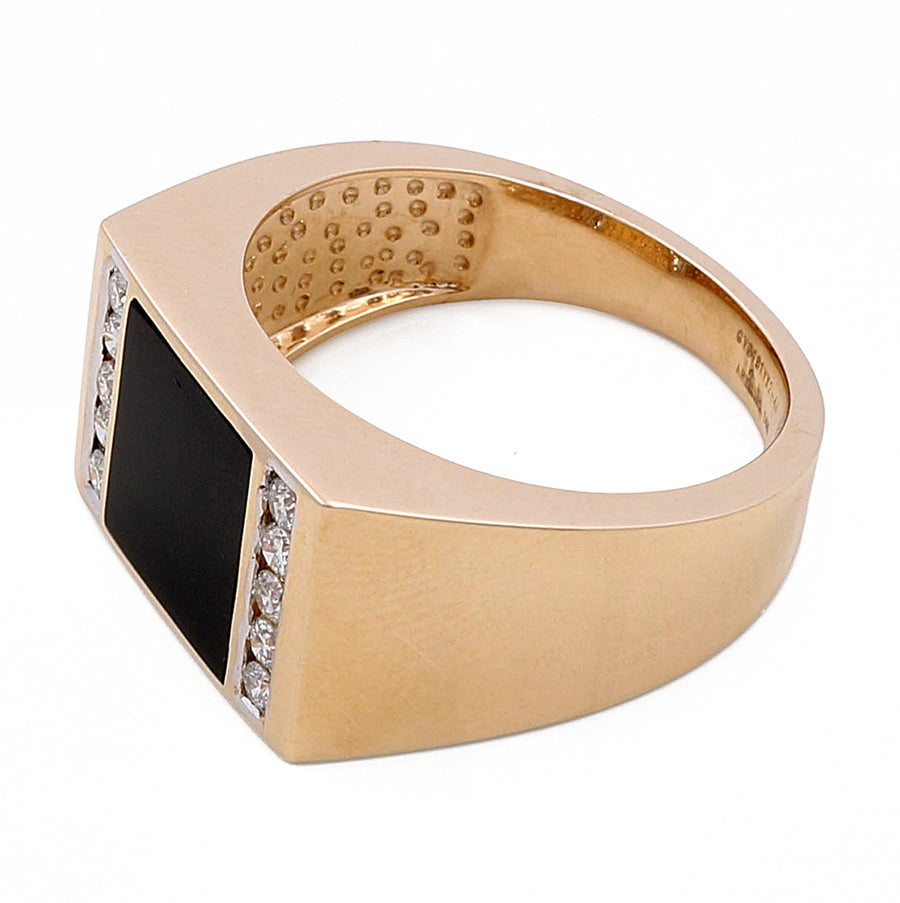 A Miral Jewelry 14k Yellow Gold Fashion Onyx Ring with 0.28Tw Round Diamonds, featuring a rectangular black stone set in the center, flanked by small round diamonds on both sides.