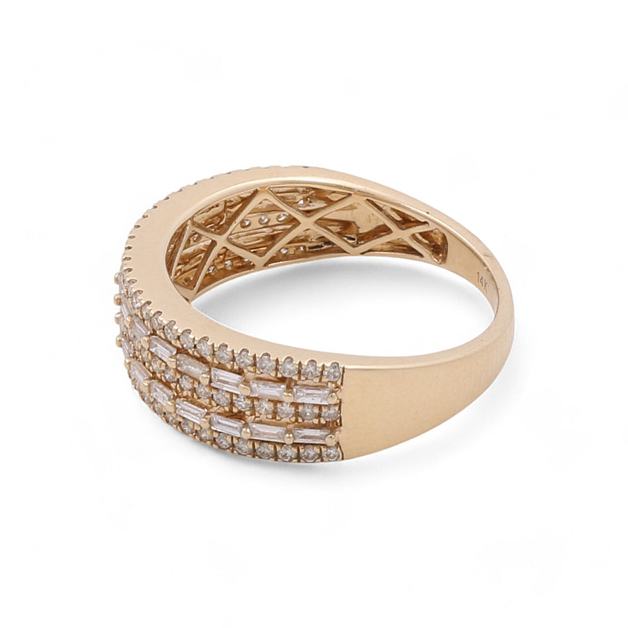 The 14K Yellow Gold Fashion Diamond Women's Ring by Miral Jewelry boasts a wide band adorned with three rows of rectangular and round-cut diamonds set across the top, along with an intricate lattice design on the inner side. This exquisite piece epitomizes luxury jewelry at its finest.