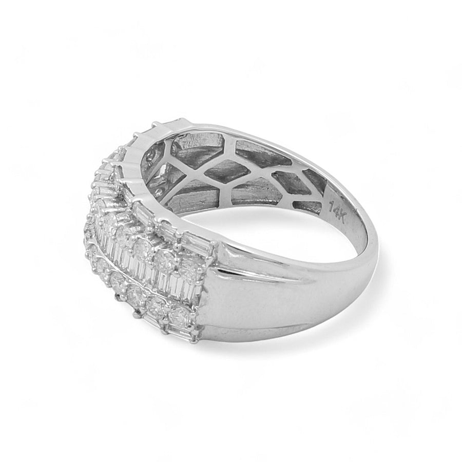 Introducing the exquisite 14K White Gold Fashion Diamond Woman Ring by Miral Jewelry. This stunning piece features a rectangular band adorned with multiple small rectangular and square gemstones set in a row, crafted in gleaming 14K white gold. The interior of the band showcases an intricate geometric pattern, stamped with "14K" for authenticity.