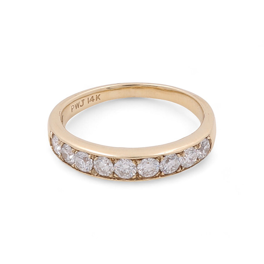 The Miral Jewelry 14K Yellow Gold Wedding Single Band Women's Ring features a stunning channel-set row of round-cut diamonds across the top.