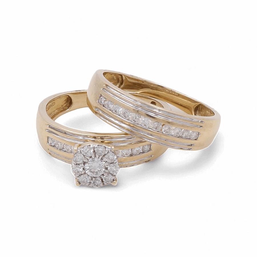 Two gold rings, one featuring a circular cluster of diamonds and the other adorned with a band of small diamonds, set against a white background. Perfect for symbolizing eternal love, this 10K yellow gold bridal woman ring with diamonds from Miral Jewelry is an exquisite choice for your special day.