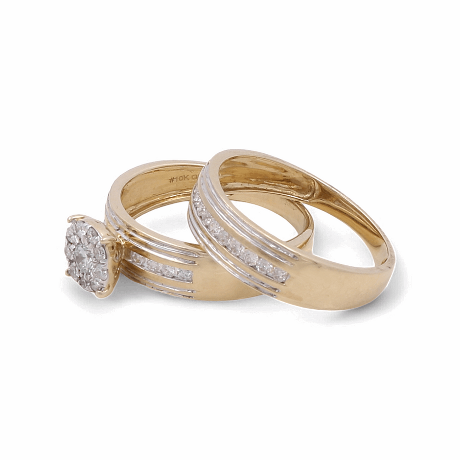 Two gold rings; the one on the left is a 10K yellow gold engagement ring from Miral Jewelry with a central diamond cluster, and the one on the right is a 10K yellow gold wedding band with small embedded diamonds. A stunning example of jewelry craftsmanship, reminiscent of a 14K White Gold Bridal Trio Ring set.