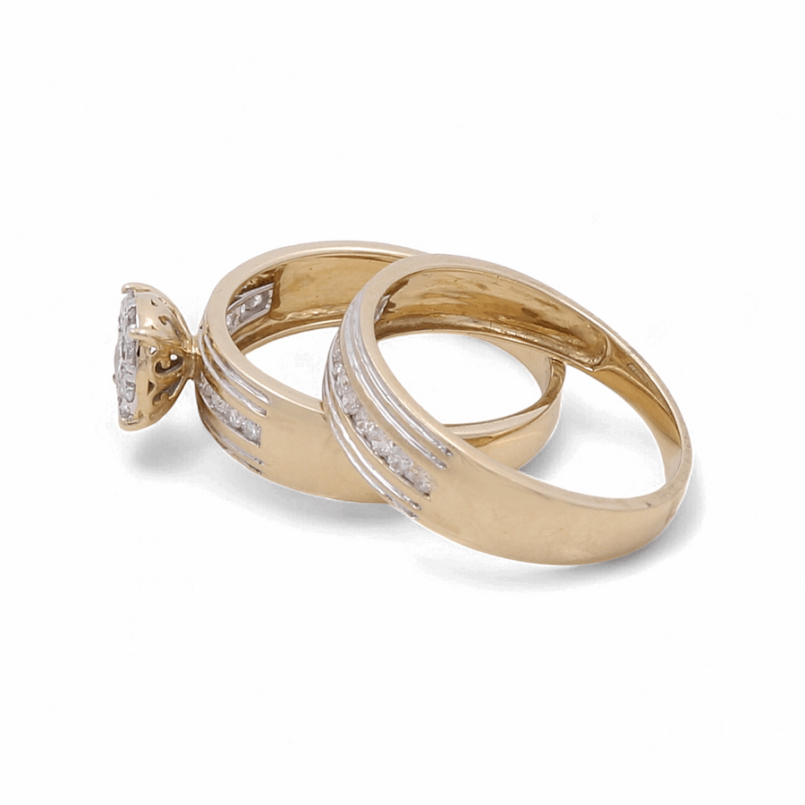 Two gold rings from Miral Jewelry, including one with a prominent diamond setting, placed next to each other on a white background, epitomize the elegance of fine jewelry. These stunning pieces perfectly complement the charm of any 10K Yellow Gold Bridal Woman Ring with Diamonds.