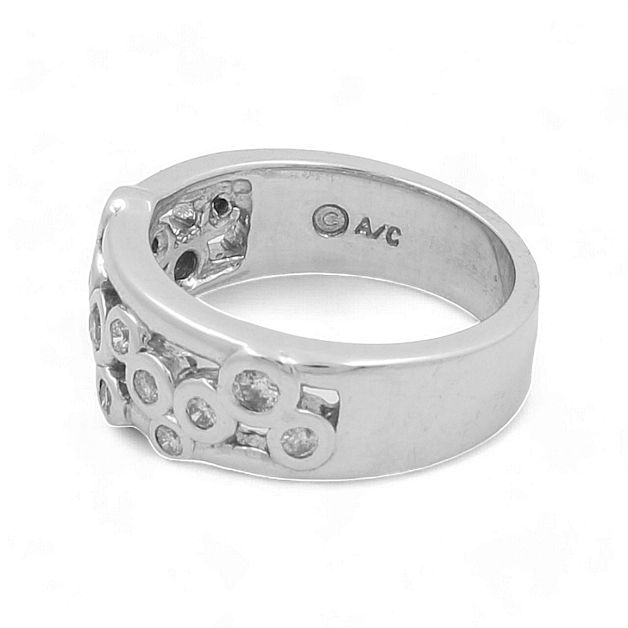 A 14K white gold fashion ring by Miral Jewelry, showcasing multiple embedded circular gemstones and an engraved "C AVC" mark on the inner band, perfect for complementing a sophisticated wedding ensemble.