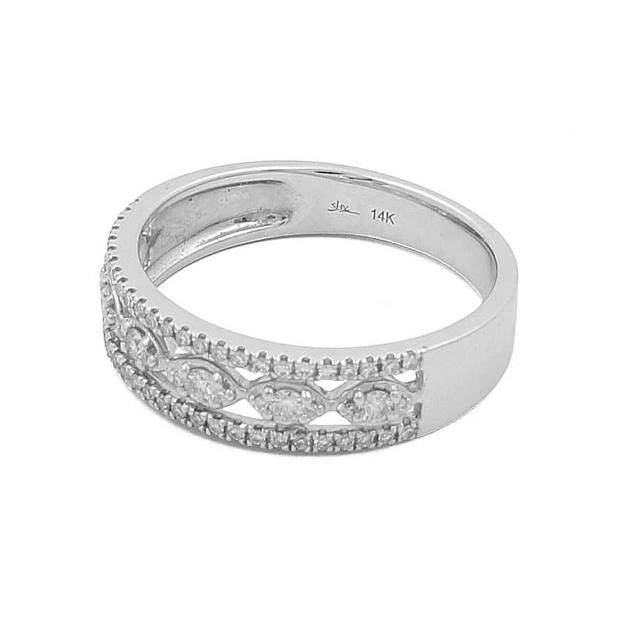 A 14K white gold luxurious accessory with a detailed, diamond-studded design on the band by Miral Jewelry, known as the 14K White Gold Woman Diamond Fashion Ring.