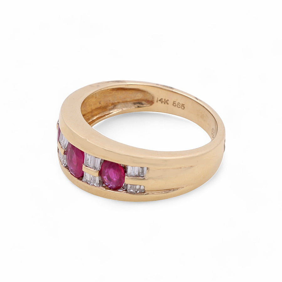 A fashion ring from Miral Jewelry featuring three rubies and four rectangular diamonds set in a row, crafted from 14K yellow gold. The inner band is marked "14K 585".