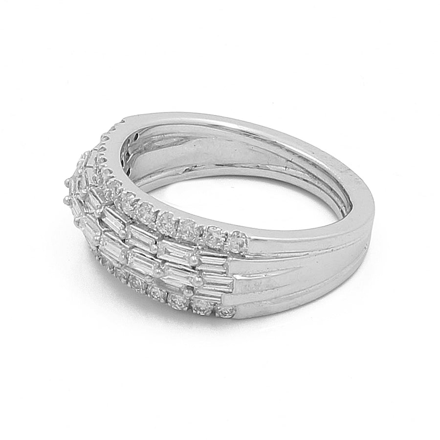 Miral Jewelry presents the White Gold 14k Contemporary Diamond Fashion Ring, showcasing a stunning band embellished with 0.50Tw baguette diamonds flanked by two rows of 0.45Tw round diamonds.