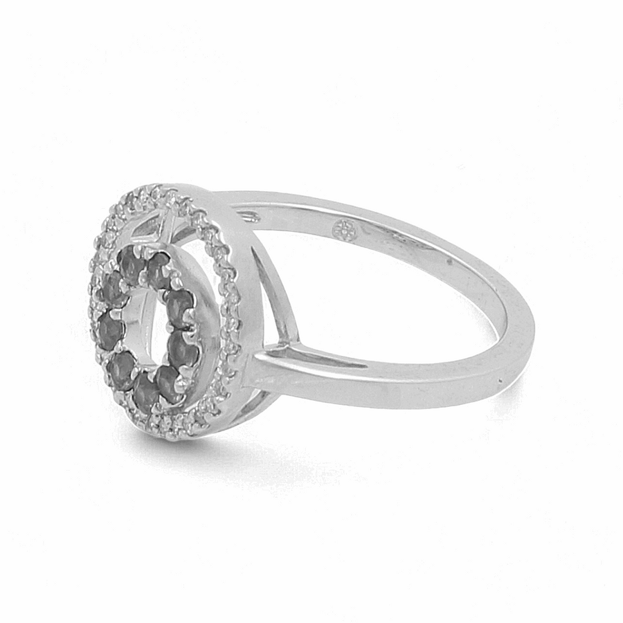 Introducing the 14K White Gold Fashion Diamond Woman Ring by Miral Jewelry: a stunning piece of fashion jewelry with a circular setting, featuring a central cut-out adorned by small dazzling gemstones. The band is sleek and smooth, and the setting is slightly raised, capturing timeless elegance perfectly.