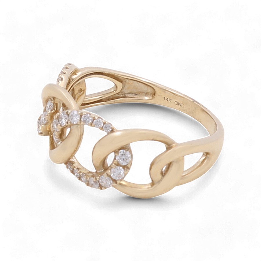 A stunning 14K yellow gold ring by Miral Jewelry, featuring an intricate intertwined chain design and adorned with delicate fashion diamonds, perfect for adding a touch of elegance to any woman's stylish collection.