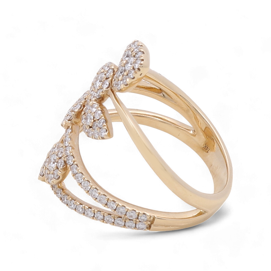 The 14K Yellow Gold Fashion Diamond Woman Ring by Miral Jewelry showcases a split band design adorned with a bow crafted from small diamonds, complemented by diamond accents along the band, making it an exquisite addition to any sophisticated collection.