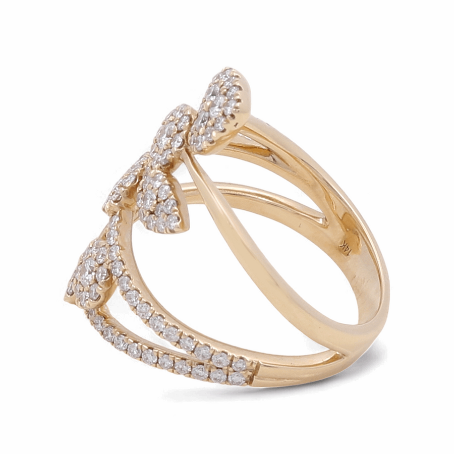 The 14K Yellow Gold Fashion Diamond Woman Ring by Miral Jewelry showcases a split band design adorned with a bow crafted from small diamonds, complemented by diamond accents along the band, making it an exquisite addition to any sophisticated collection.