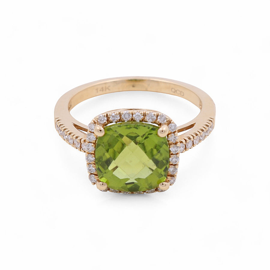 Introducing the exquisite 14K Yellow Gold Woman Fashion Ring by Miral Jewelry, showcasing a captivating large green square gemstone at its center, artistically framed by smaller diamonds along the band and encircling the central stone.