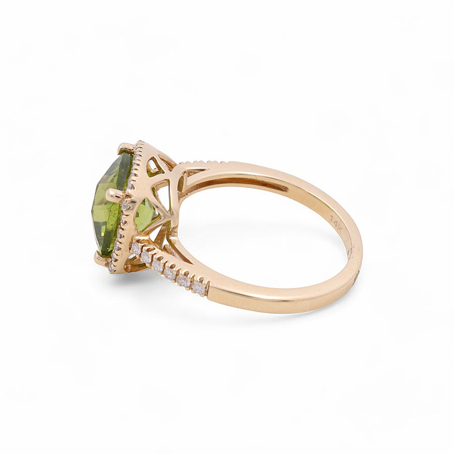 The Miral Jewelry 14K Yellow Gold Woman Fashion Ring showcases a striking large green gemstone encased in a lattice-style setting, complemented by small diamonds and rubies adorning the band.