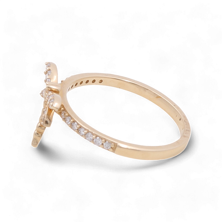 Introducing the Miral Jewelry 14K Yellow Gold Fashion Diamond Woman Ring, featuring a striking cross-shaped design enhanced by small diamonds on both the band and the cross. Crafted to perfection for a touch of elegance.