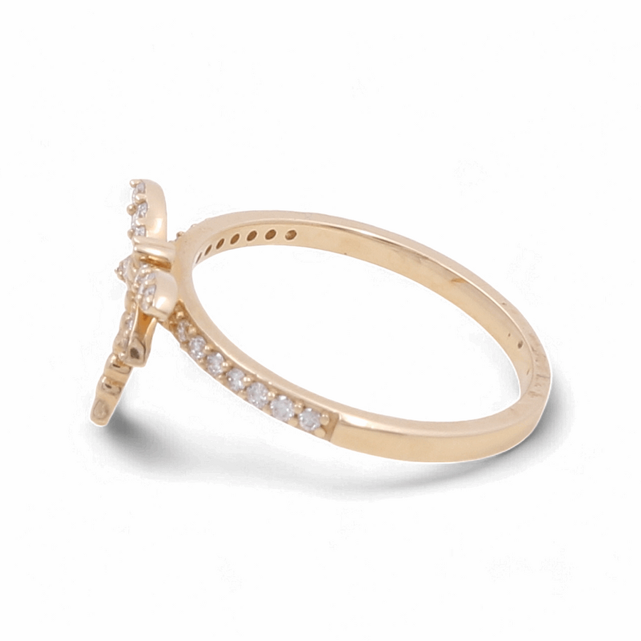 Introducing the Miral Jewelry 14K Yellow Gold Fashion Diamond Woman Ring, featuring a striking cross-shaped design enhanced by small diamonds on both the band and the cross. Crafted to perfection for a touch of elegance.