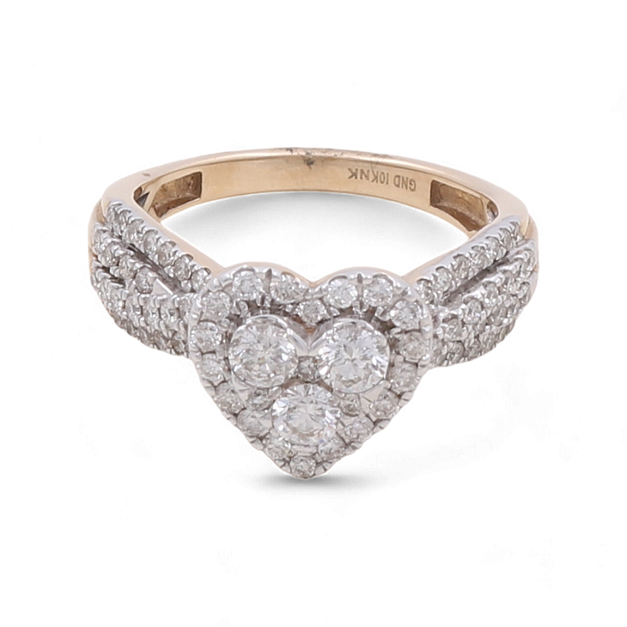 The 10K Yellow Gold Fashion Diamond Woman Ring by Miral Jewelry, featuring a heart-shaped design with three prominent central diamonds surrounded by smaller diamonds, and additional diamond encrusting along the gold band, epitomizes Luxury Statement Jewelry.