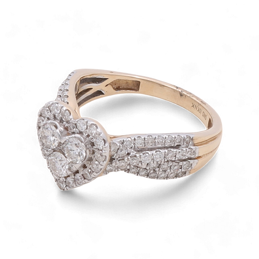 Introducing the 10K Yellow Gold Fashion Diamond Woman Ring by Miral Jewelry, a stunning piece that features a heart-shaped cluster of sparkling diamonds and a split shank band embellished with additional diamonds, embodying timeless design.