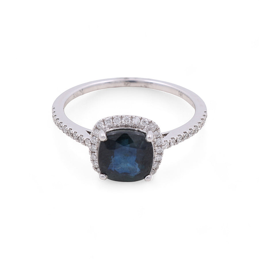 The Miral Jewelry 14K Yellow Gold Woman Fashion Ring with Diamonds and Sapphire features a large blue sapphire in the center, surrounded by small clear diamonds, showcasing luxury and elegance.