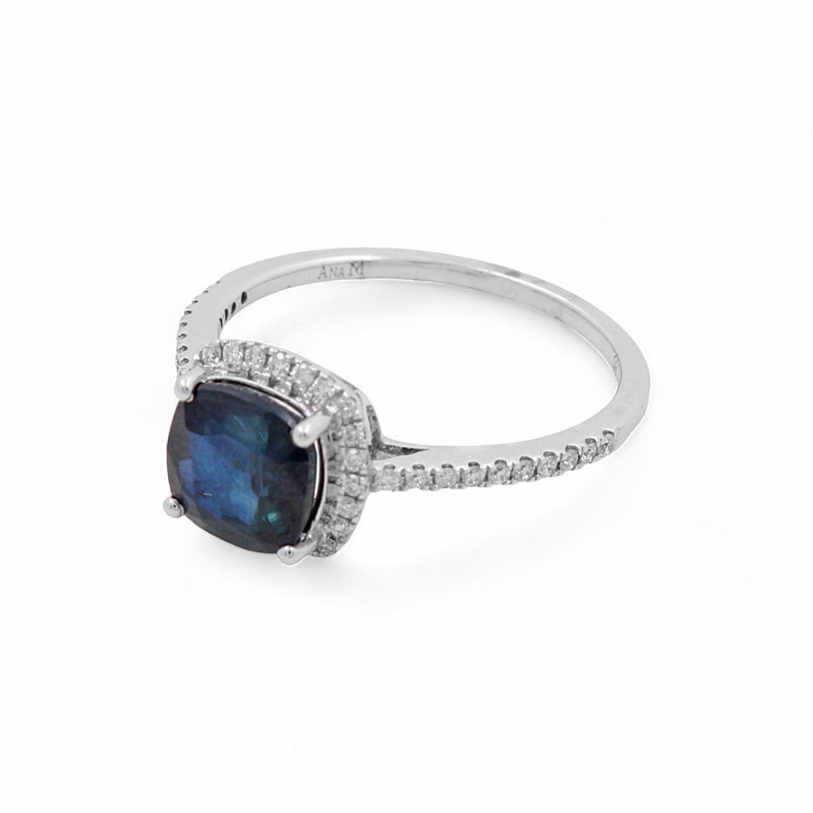 The 14K Yellow Gold Woman Fashion Ring with Diamonds and Sapphire from Miral Jewelry features a large dark blue gemstone in the center, complemented by small clear stones encrusting the band and setting, perfect for adding a touch of elegance to any woman's fashion collection.