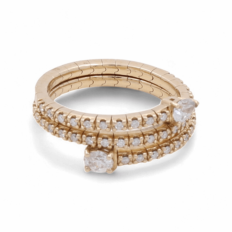 The 14K Yellow Gold Fashion Diamond Woman Ring by Miral Jewelry is a luxury piece featuring two pear-shaped diamonds and multiple small round diamonds arranged in three elegant rows, making it a stunning addition to any jewelry collection.