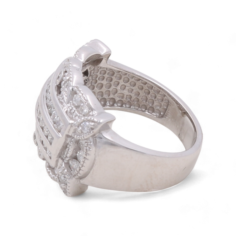 This exquisite accessory, the 14K White Gold Fashion Diamond Woman Ring by Miral Jewelry, features a wide band with a square, raised setting adorned with small round diamonds. The inner side of the band boasts a dotted texture for added detail.