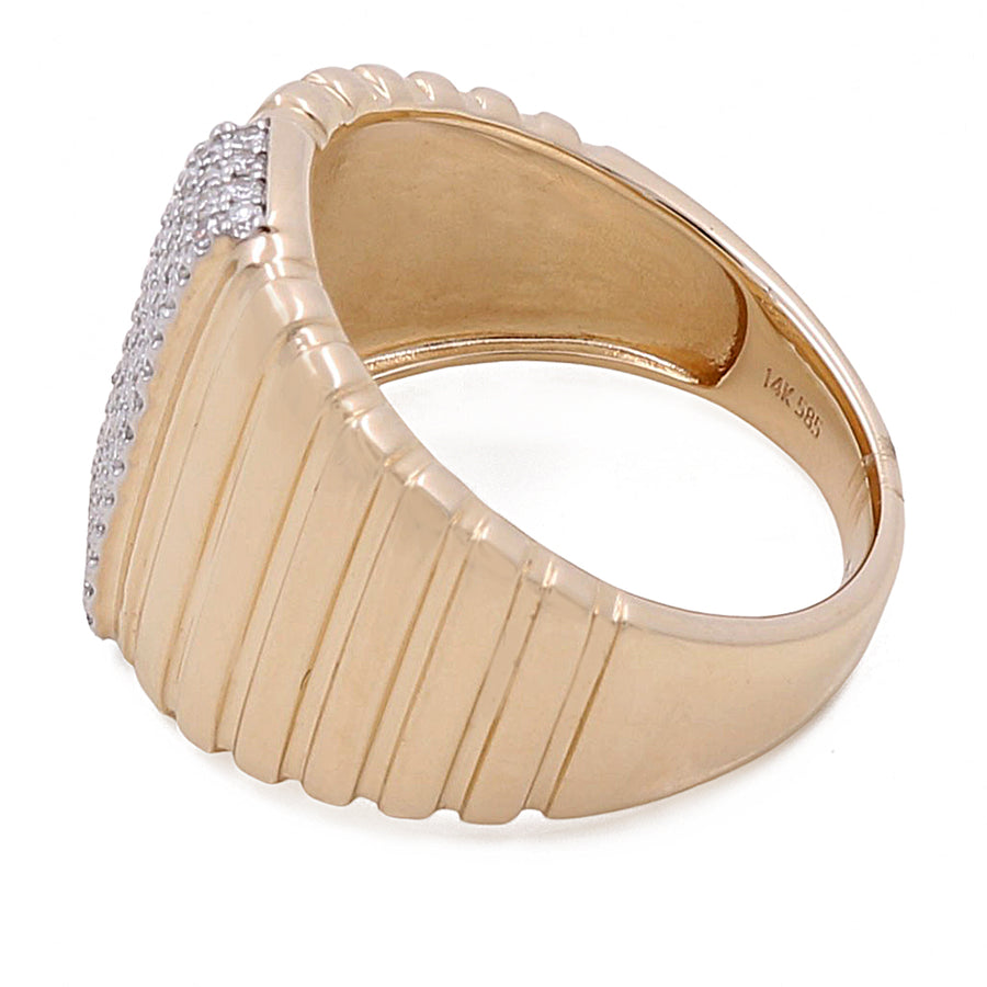 A 14k Yellow Gold Fashion Ridge Ring with 0.23Tw Round Diamonds by Miral Jewelry with a ribbed design on the band and a rectangular cluster of small round diamonds on top. The inside of the band is stamped with "14K" and "585".