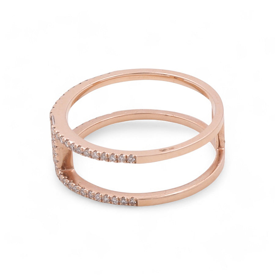 The 14K Rose Gold Fashion Diamond Women's Ring by Miral Jewelry features a double band design with small, clear stones embedded along one side, set against a white background.