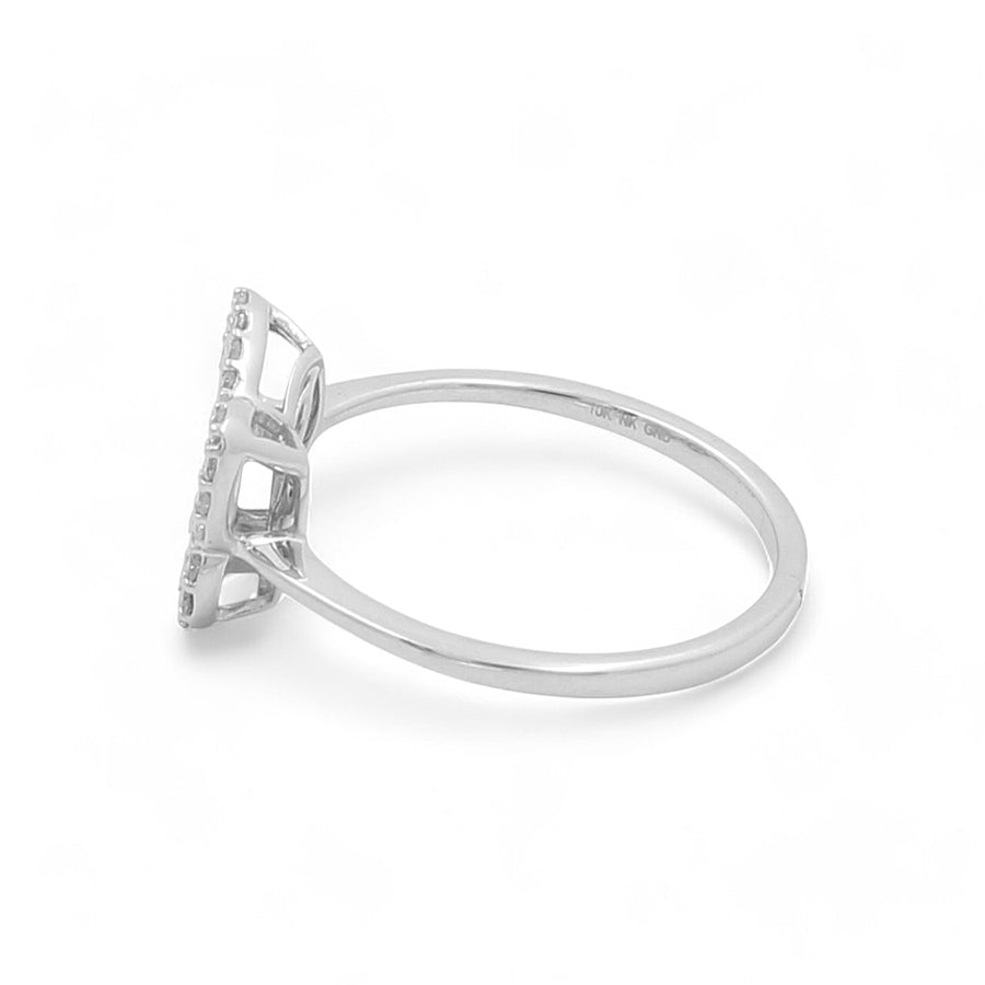 The 10K White Gold Fashion Butterfly Diamond Women's Ring by Miral Jewelry features a rectangular setting with a side view showcasing a solitaire design, enhanced by small embedded diamonds that elevate the main stone. The band is plain and polished, making it an exquisite addition to any woman's jewelry collection.