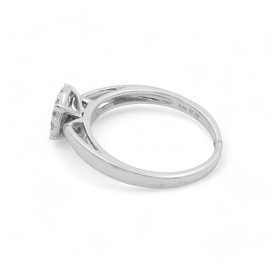 The 14K White Gold Engagement Women's Ring by Miral Jewelry features a solitaire setting with 0.20Tw round diamonds and a small inscription on the inner band, making it perfect for the modern woman.