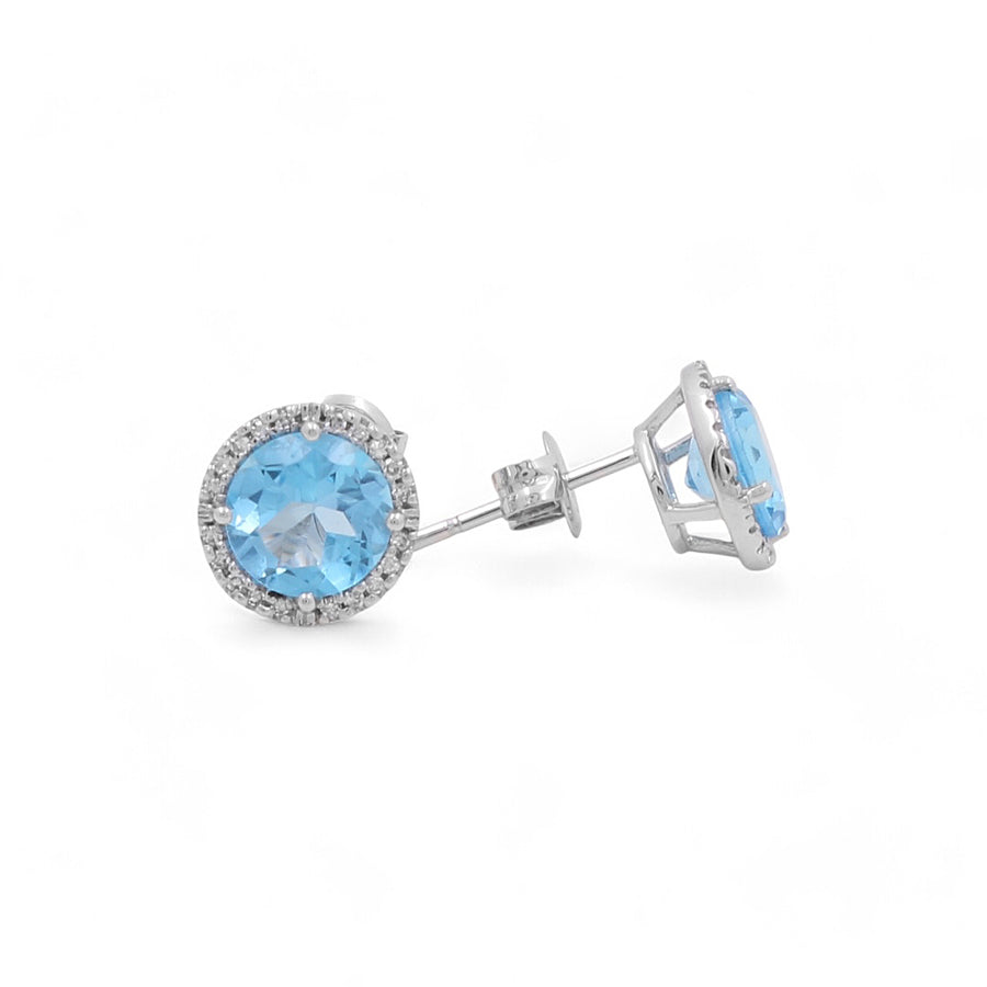 Presenting Miral Jewelry's 14K White Gold Blue Round Fashion Women's Earrings, these stunning pieces feature blue round gems encircled by small diamonds and are impeccably displayed on a white background.