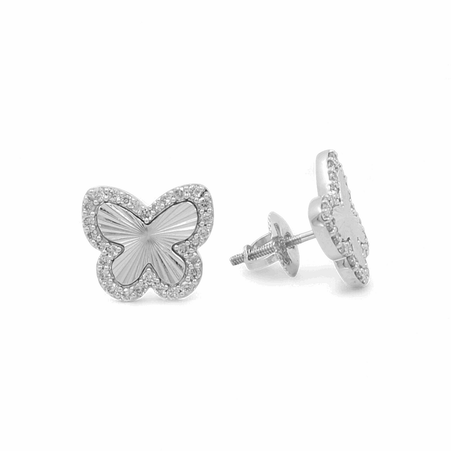 Discover the elegance found in our 10K White Gold Fashion Butterfly Diamond Women's Ring collection from Miral Jewelry, illustrated by a pair of butterfly-shaped stud earrings crafted from 10K gold. These earrings feature a textured center and a border of small stones, with one earring facing forward and the other shown from a side angle on a white background.