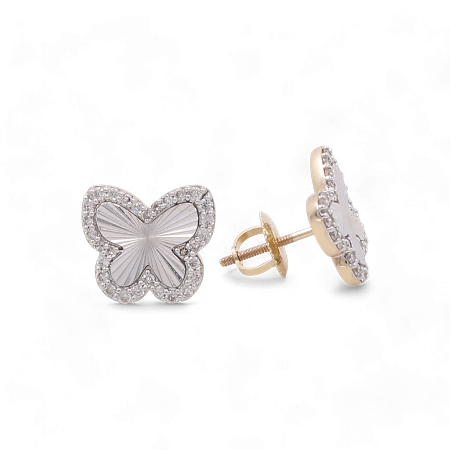 A pair of butterfly-shaped stud earrings with a white center and diamond-studded edges, featuring 10K yellow gold backing and posts, by Miral Jewelry.