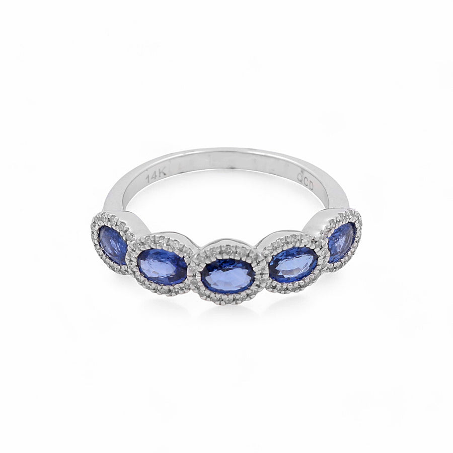 A breathtaking 14K white gold women's ring by Miral Jewelry, showcasing five oval sapphires arranged in a row, each surrounded by a halo of small diamonds.