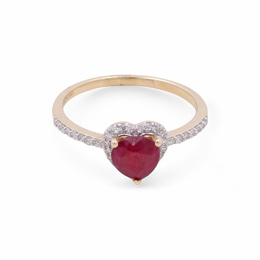 The Miral Jewelry 14K Yellow Gold Woman Fashion Ring features a heart-shaped ruby at the center, surrounded by small diamonds with additional diamond accents on the band. Perfect for adding elegance to any woman's fashion collection.