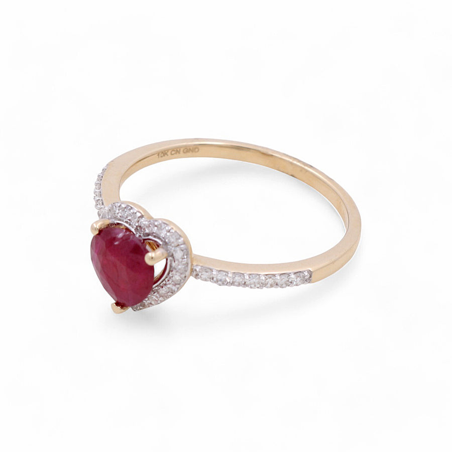 Miral Jewelry's 14K Yellow Gold Woman Fashion Ring with Diamonds and Heart Ruby showcases a stunning heart-shaped ruby encircled by glistening diamonds, all set against a white background.