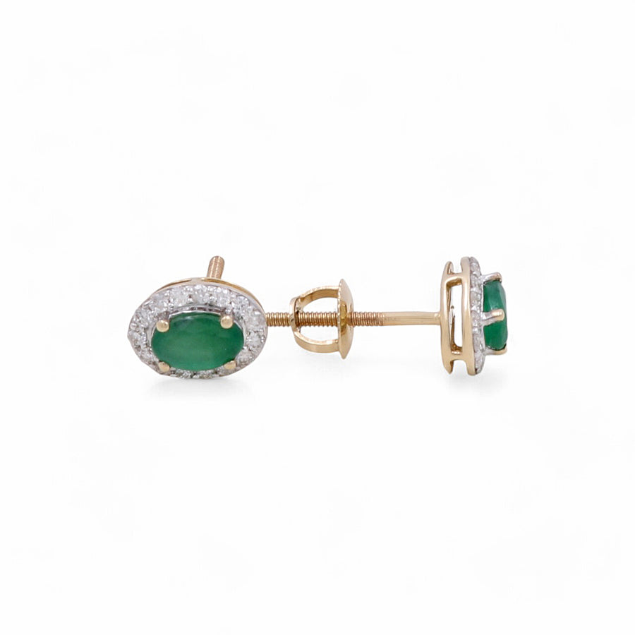 A pair of Miral Jewelry 14K Yellow Fashion Earrings with oval emerald gemstones and a halo of smaller clear diamonds set around them.