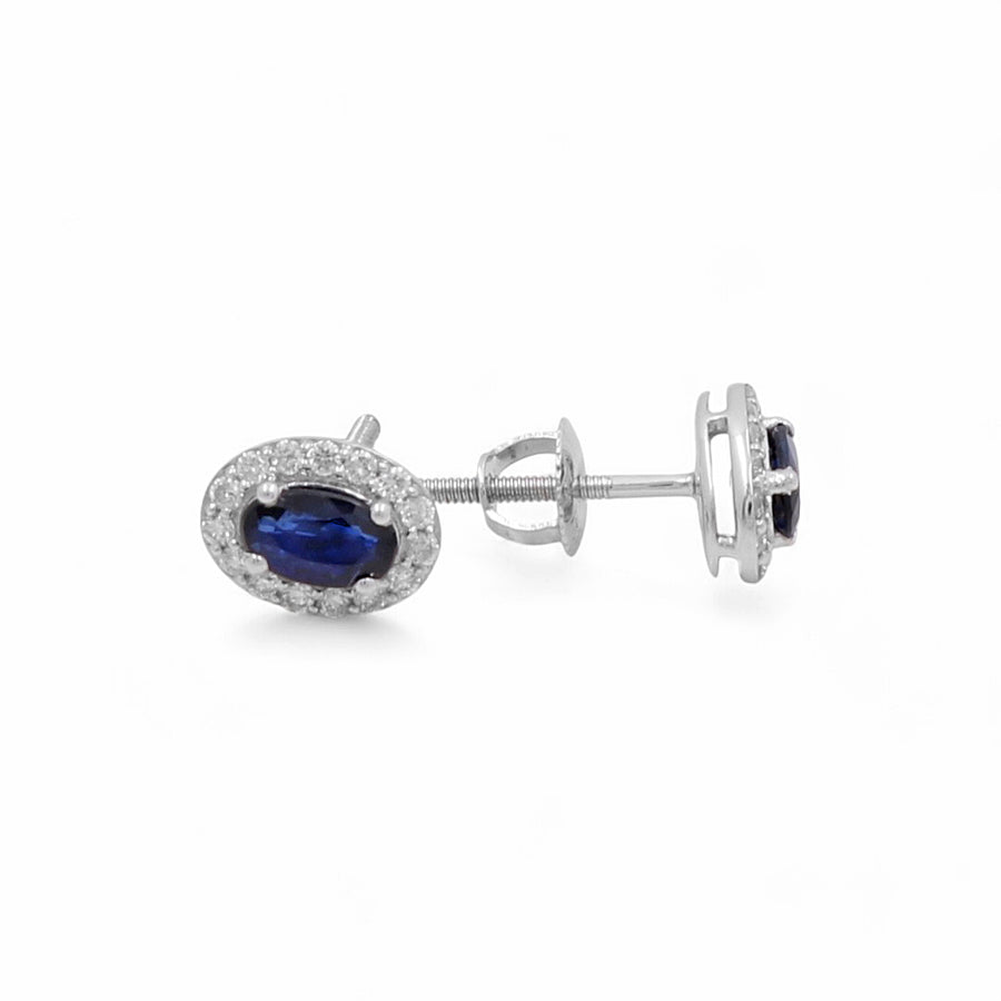 Introducing the 14K White Gold Fashion Women's Earrings by Miral Jewelry, showcasing stunning oval blue sapphires encircled by sparkling clear diamonds and secured with screw-back closures.