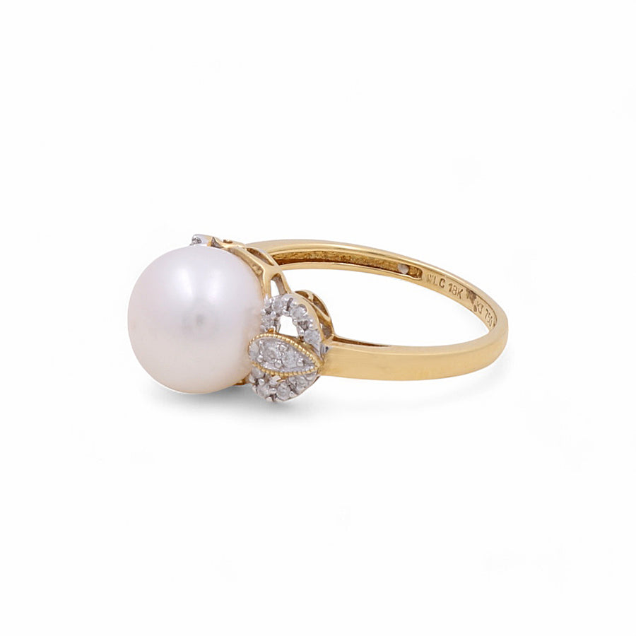 The Miral Jewelry 14K Yellow Gold Fashion Women's Ring features an exquisite combination of a large pearl and dazzling diamond accents on the band, making it perfect for fashion-conscious women.