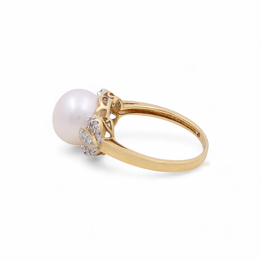 This luxurious 14K Yellow Gold Fashion Women's Ring by Miral Jewelry showcases a large white pearl encircled by small diamonds, elegantly set in a decorative band.