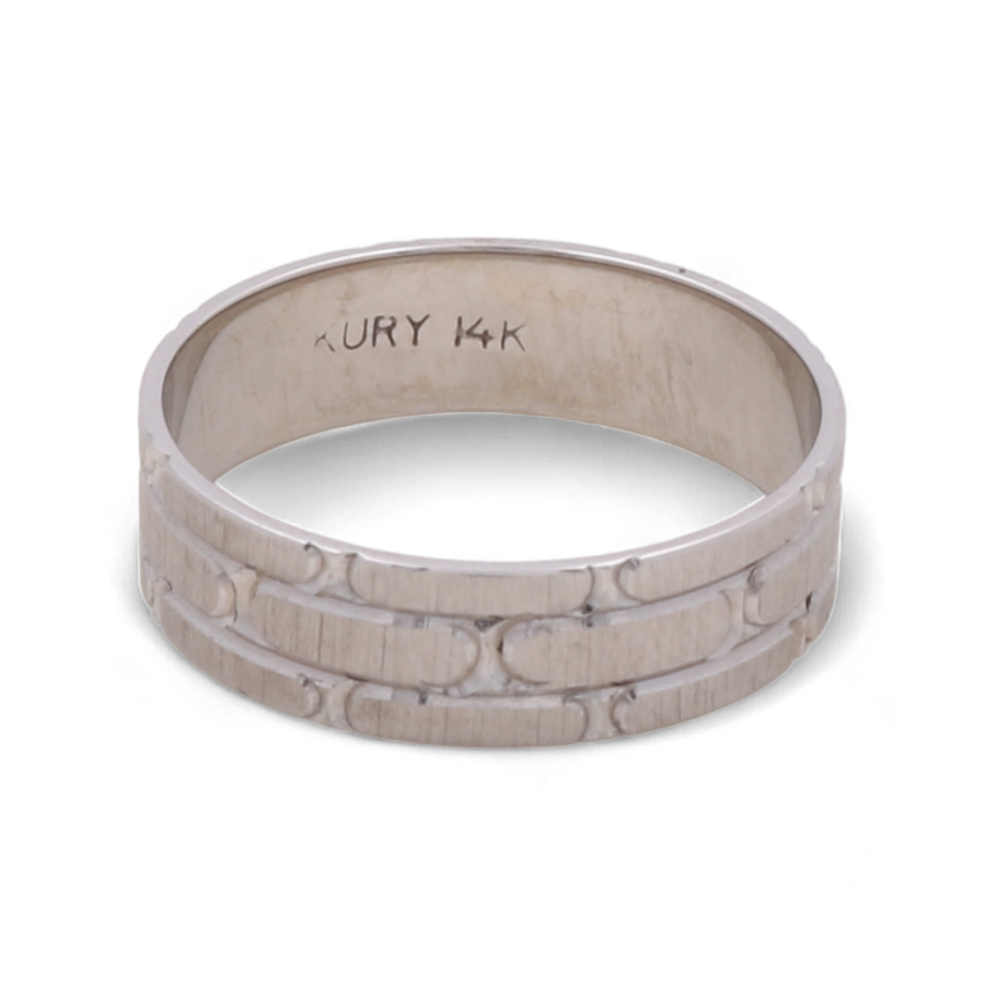 The 14K White Gold Wedding Men Ring by Miral Jewelry features an engraved pattern and the inscription "KURY 14K" on the inner band. This luxurious piece is a timeless symbol of enduring commitment.