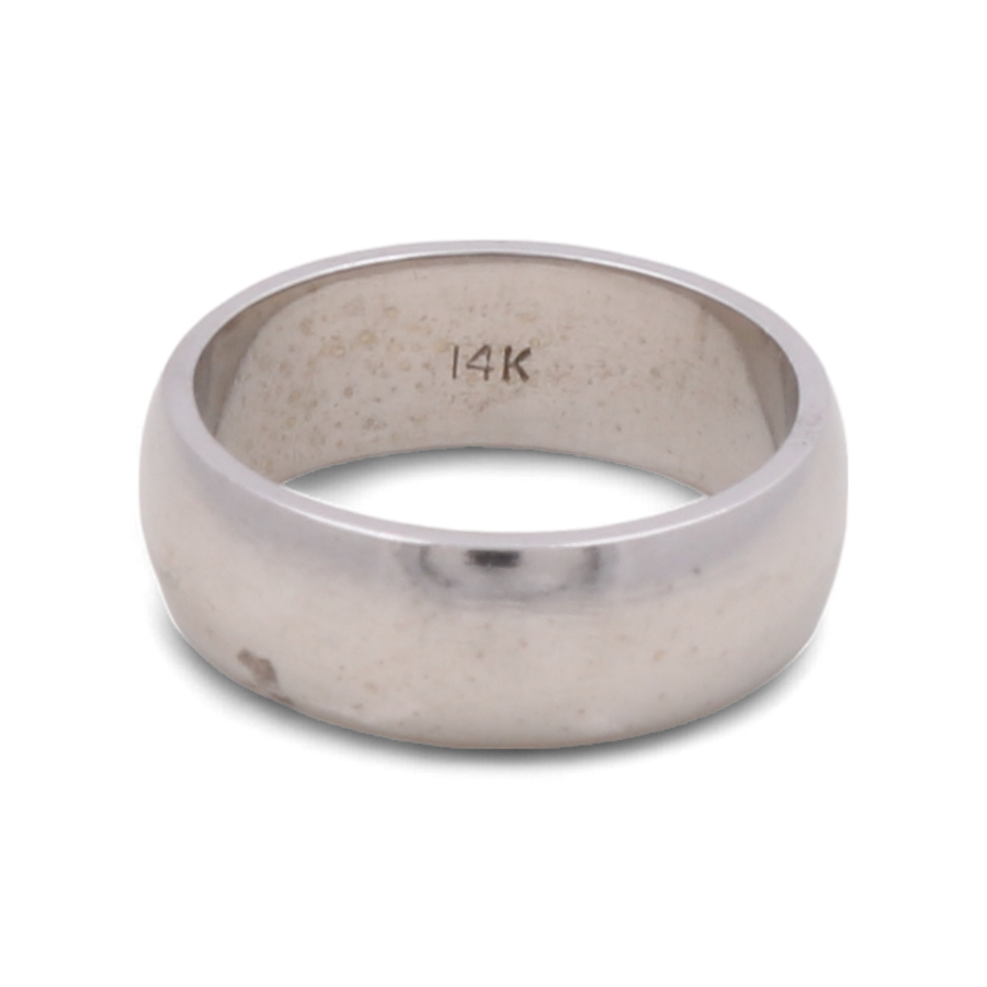 A 14K white gold men's wedding ring from Miral Jewelry with "14K" engraved on the inner side.